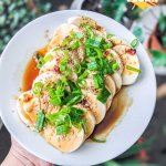 Cold tofu dish with chili oil and soy sauce, topped with sesame and scallions