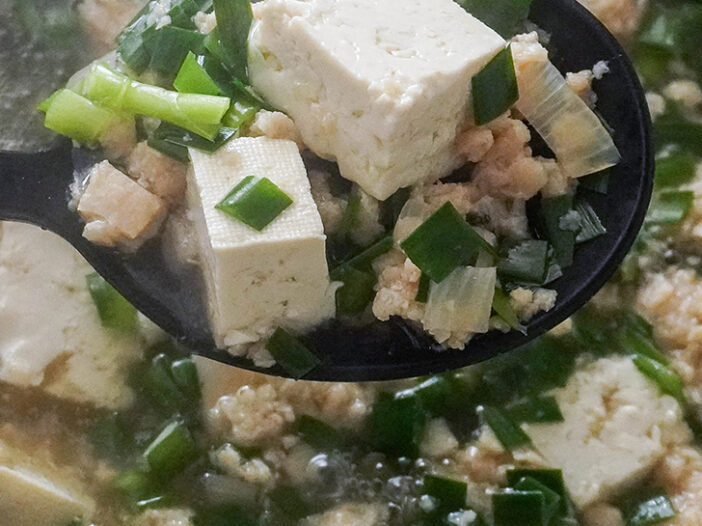 vietnamese tofu and flat chive soup in a ladle