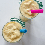 vegan orange cream milkshake in two glasses with colourful silicone straws